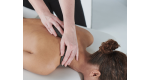 Woman receiving a massage on shoulders and back