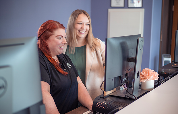 Manager at Massage Envy franchised location standing next to staff member. 