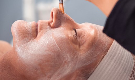Woman receiving age-defying facial at Massage Envy franchised location.  
