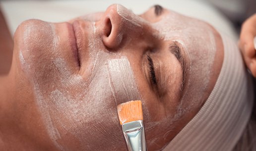 Woman receiving tone-balancing facial at Massage Envy franchised location. 