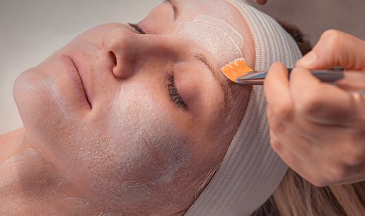 Woman receiving calming facial at Massage Envy franchised location. 