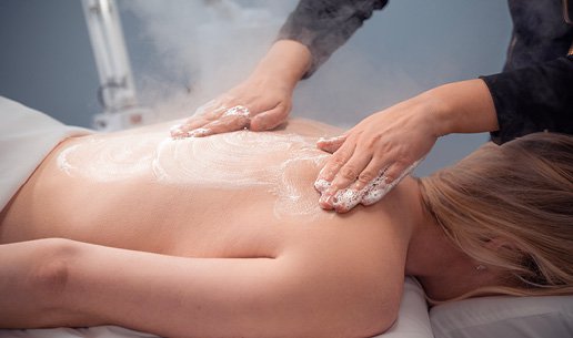 Woman receiving back facial at Massage Envy Clinic. 
