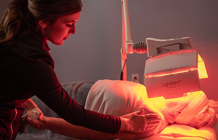 Close-up of a woman receiving an Age-Defying Nourishing Light Treatment. 