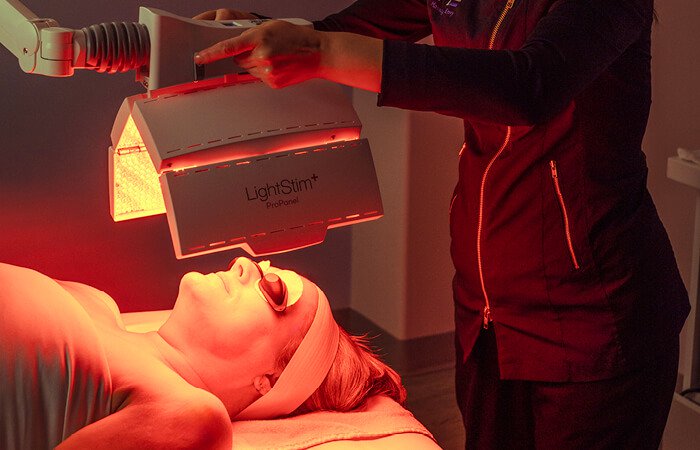 Close-up of a woman receiving a Tone-Balancing Nourishing Light Treatment. 