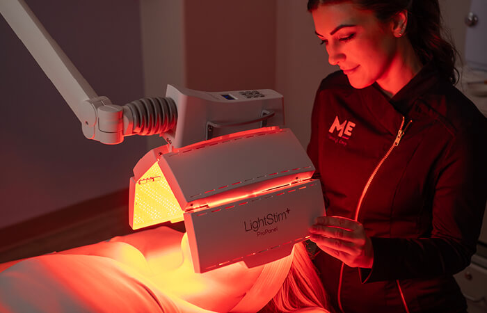 Close-up of a woman receiving a Calming Nourishing Light Treatment. 