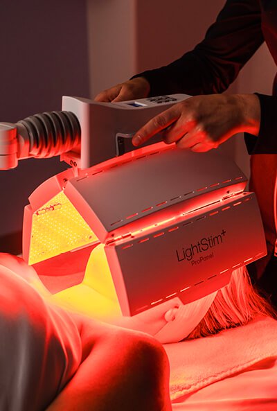 Close-up of a woman receiving LED Light Therapy during a Clarifying Acne Nourishing Light Treatment. 
