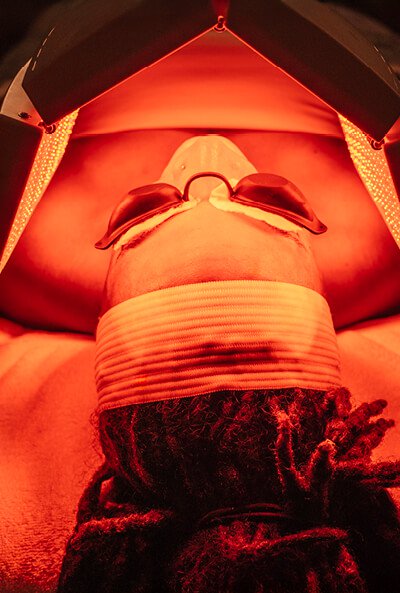 Close-up of a woman's face during a Brightening Nourishing Light Treatment. 