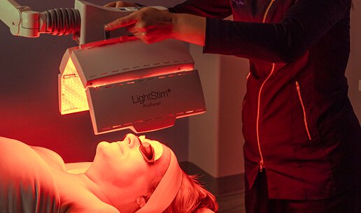 Woman receiving Tone-Balancing Nourishing Light Treatment. 
