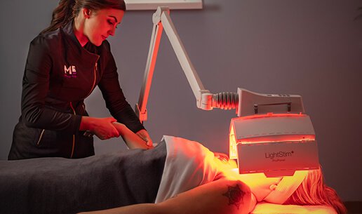 Woman receiving Clarifying Acne Nourishing Light Treatment. 