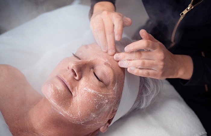 Woman receiving age-defying facial at Massage Envy franchised location.  