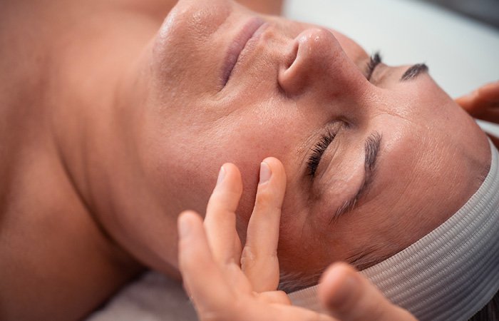 Woman receiving tone-balancing facial at Massage Envy franchised location. 