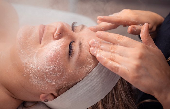Woman receiving clarifying acne facial at Massage Envy franchised location. 
