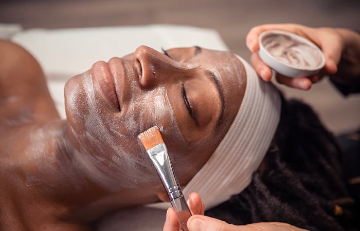 Woman receiving brightening facial at Massage Envy franchised location. 