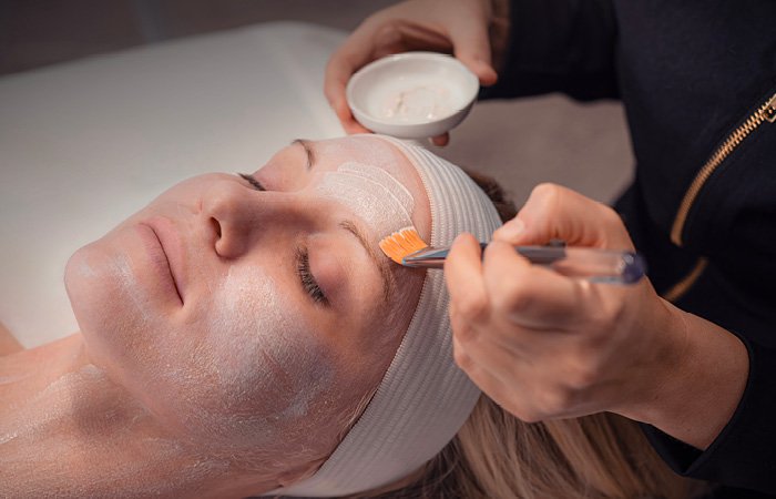 Woman receiving calming facial at Massage Envy franchised location. 