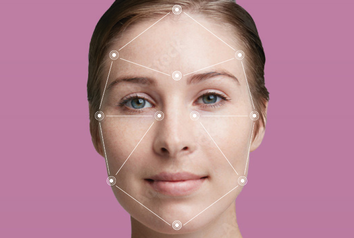Close-up of a woman's face with markings from an AI smart scanner technology analyzing her face. 