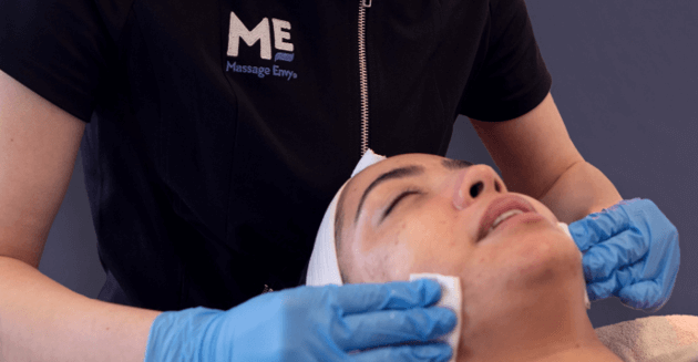 Woman with her eyes closed during facial service at Massage Envy. 