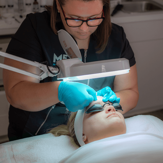 Woman receiving a customized chemical peel session at Massage Envy.