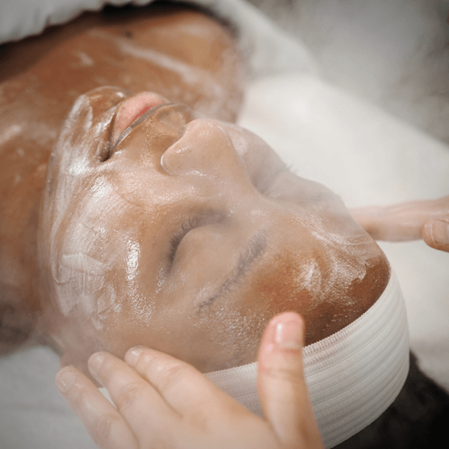 Woman receiving a customized facial with Jan Marini products.