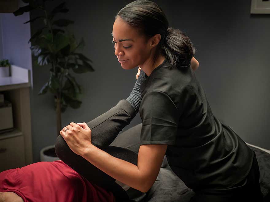 Smiling therapist providing stretch service